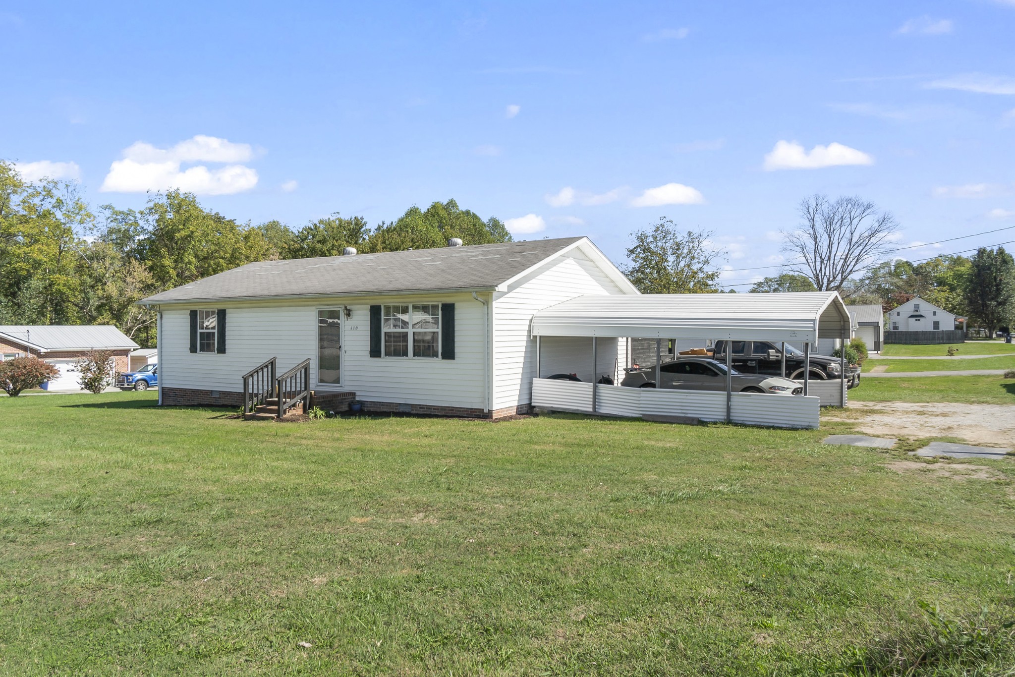 a view of a house with a yard and sitting area