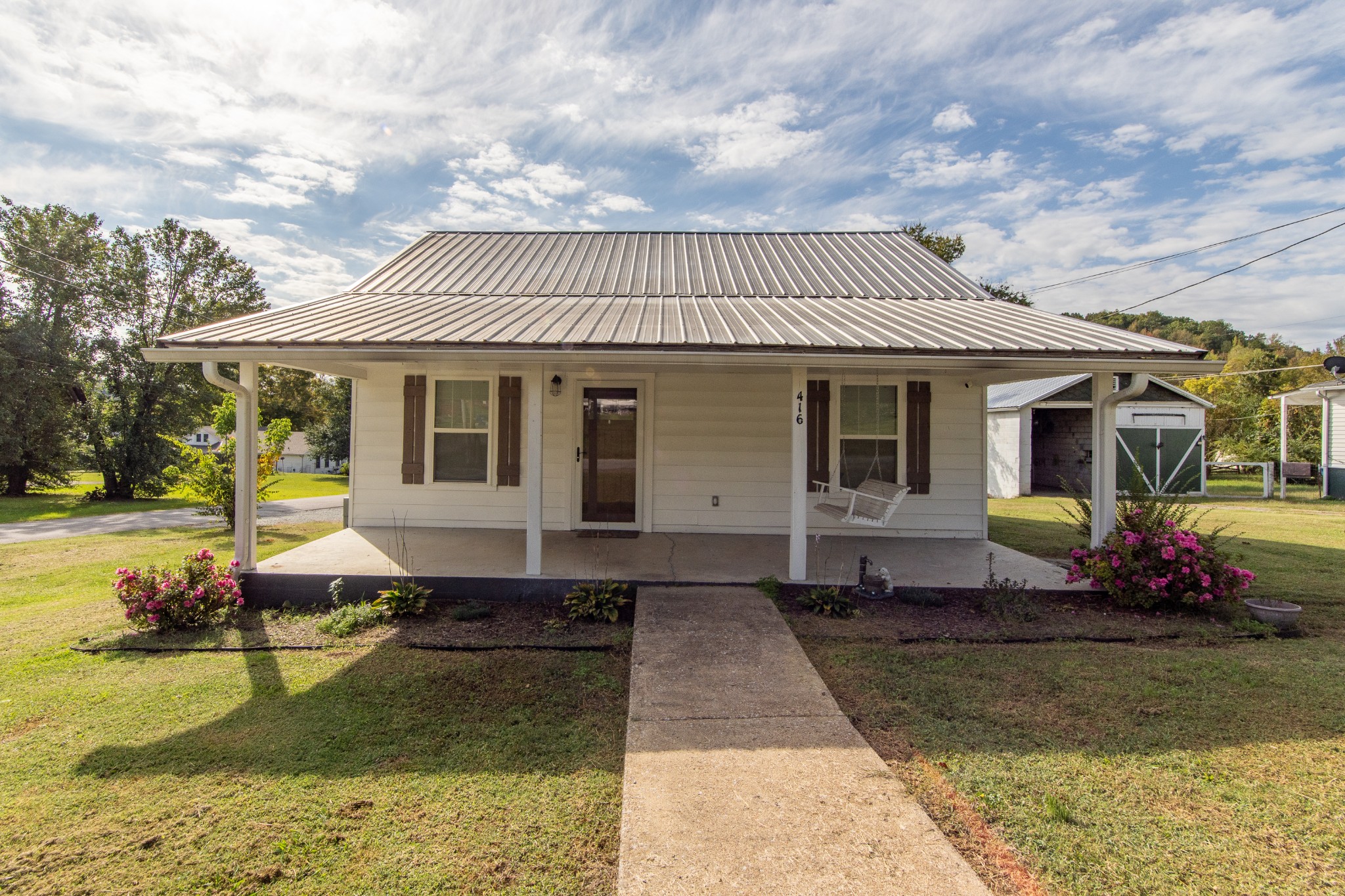 a front view of a house with garden