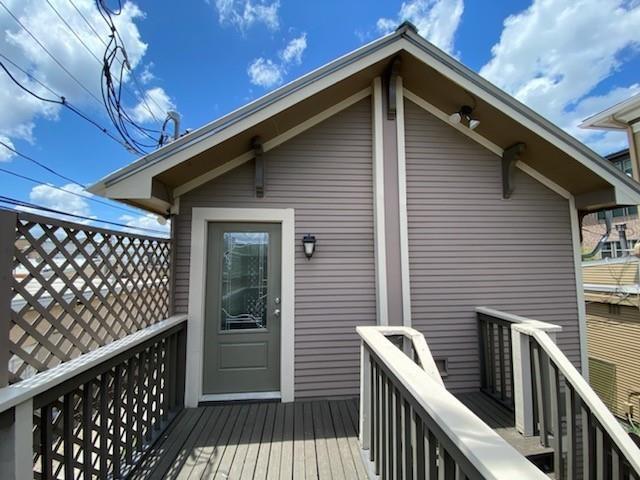 a front view of a house with glass door and deck