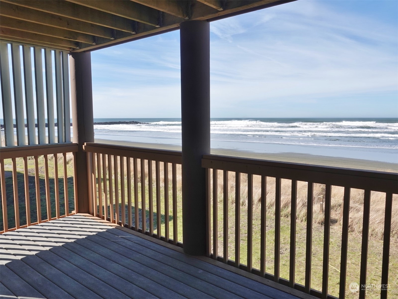 a view of wooden balcony with a floor to ceiling window