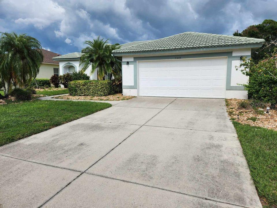 a front view of a house with a yard and garage