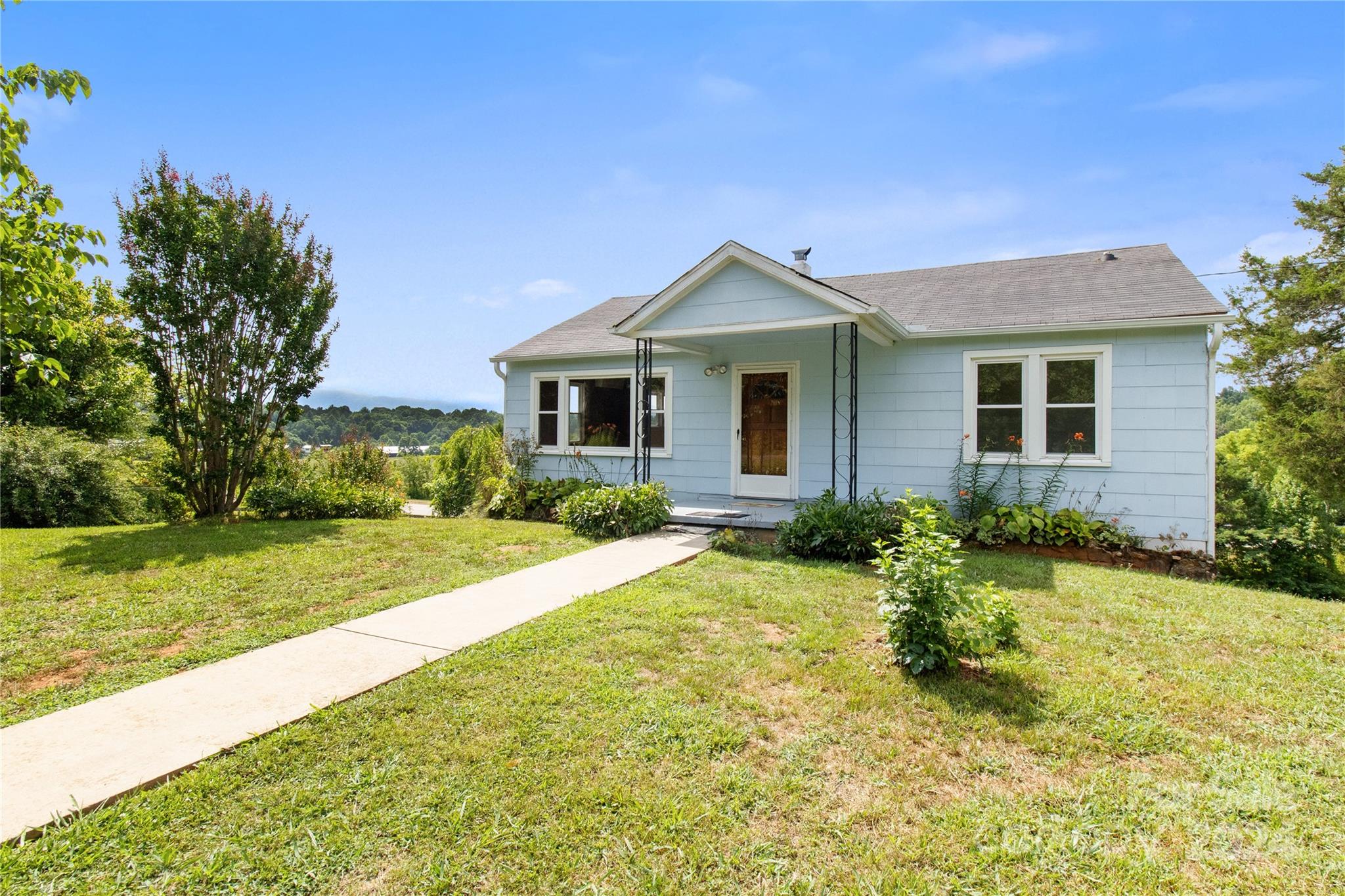 a front view of house with yard and green space