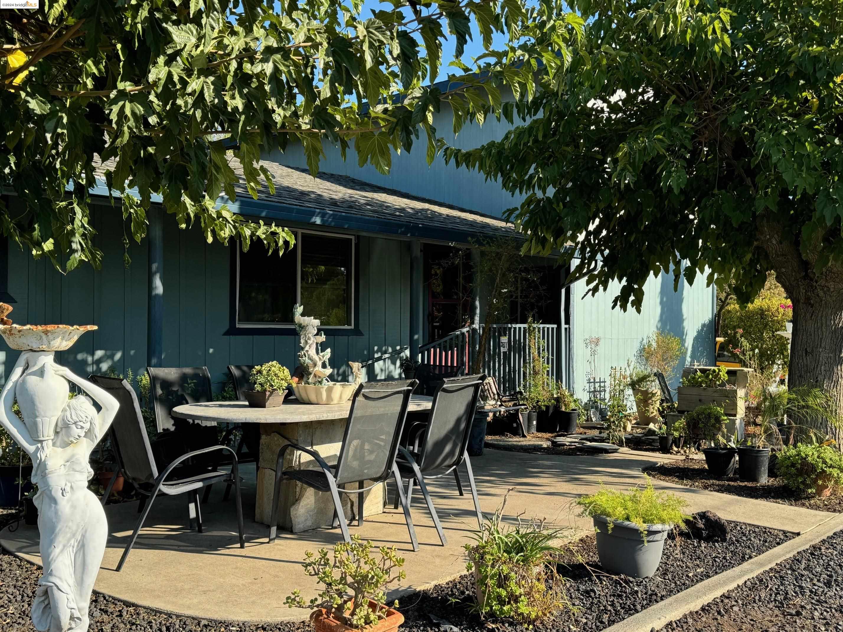 a view of a house with swimming pool and sitting area