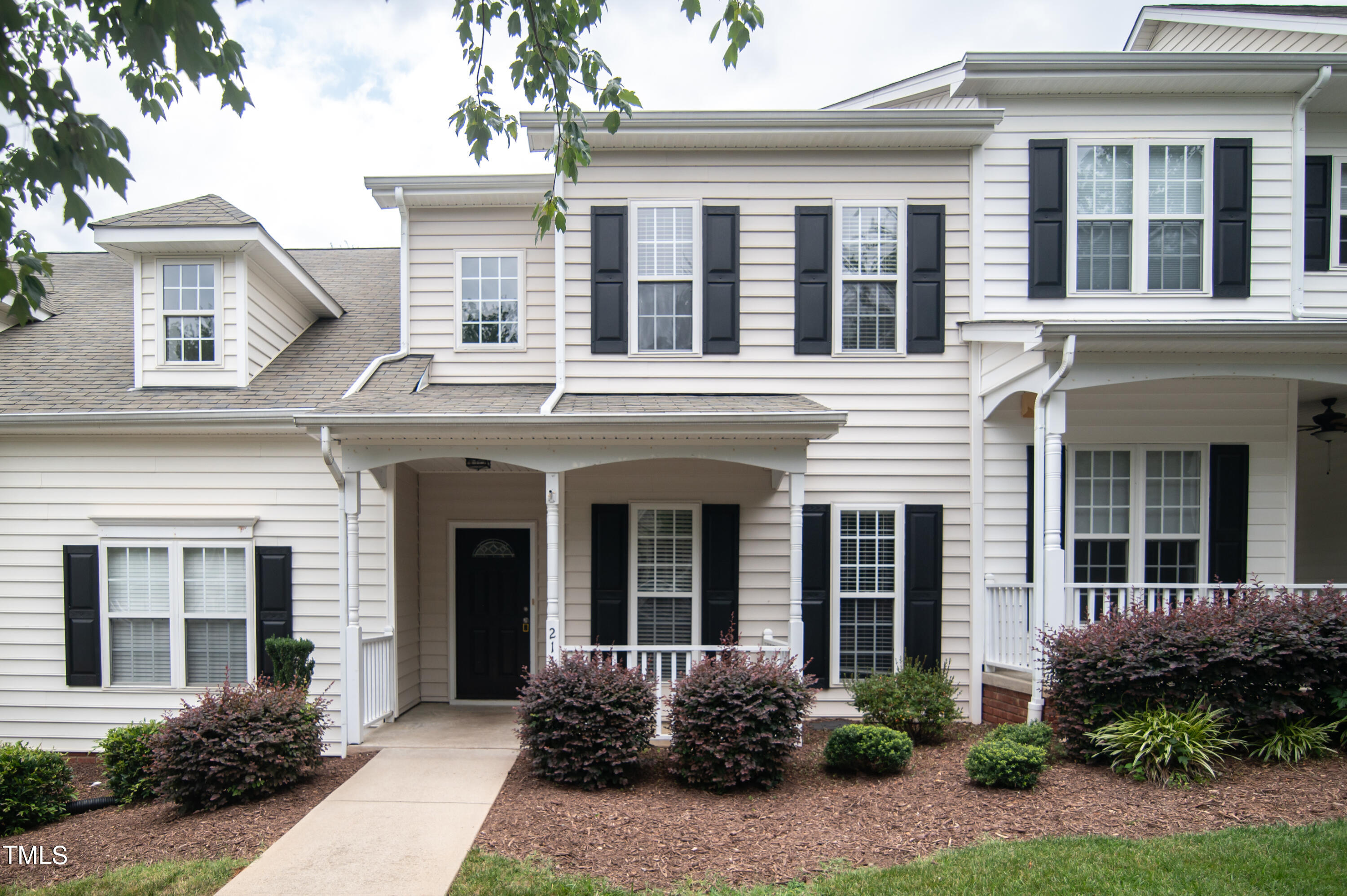 front view of a brick house with a yard