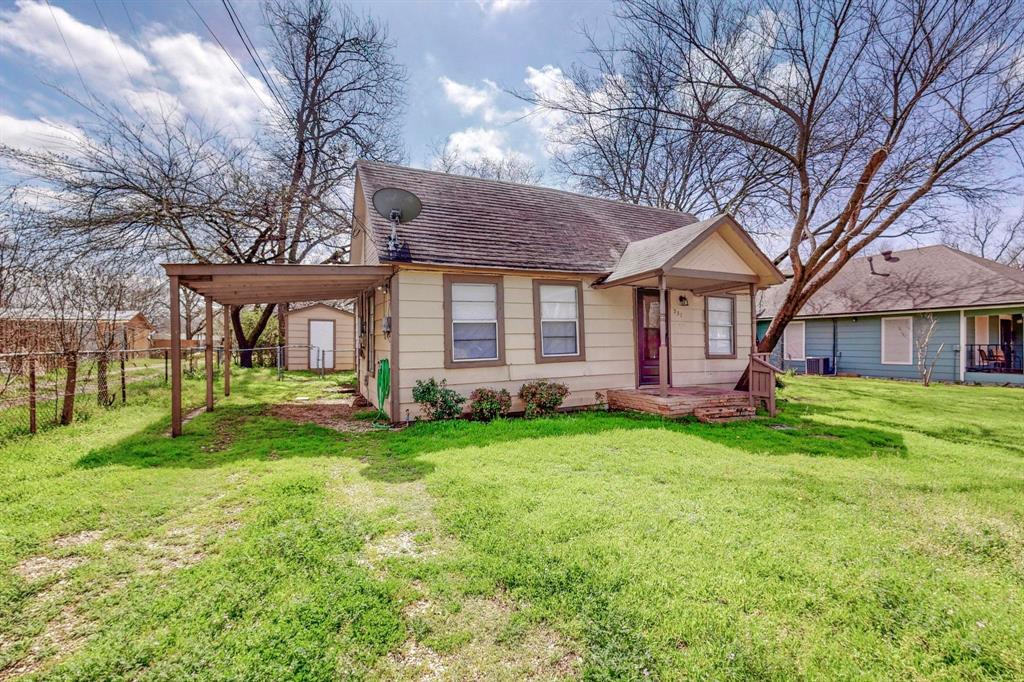 a view of a house with a yard porch and sitting area