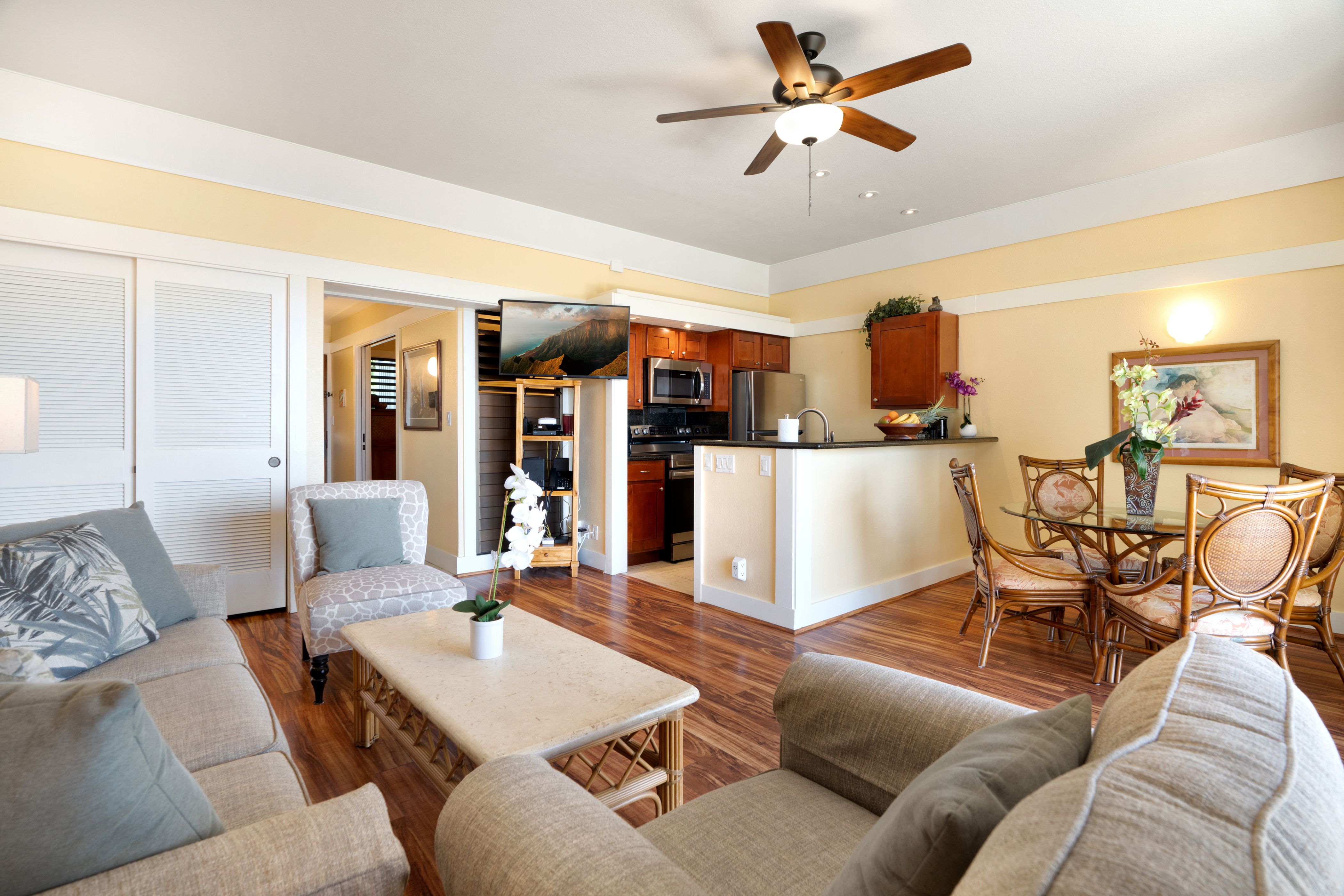 a living room with furniture and kitchen view