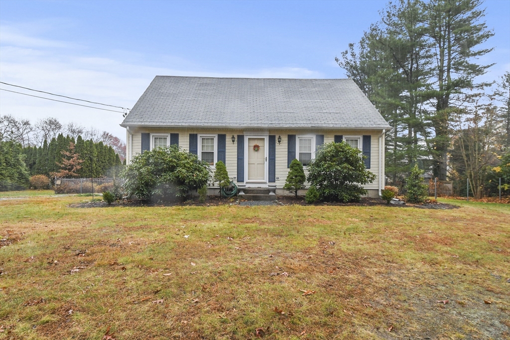 a front view of house with yard and green space