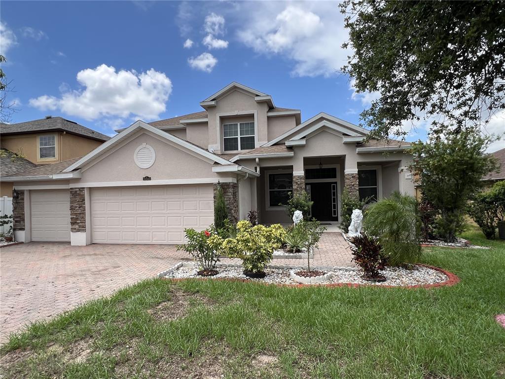 a front view of a house with a yard and garage