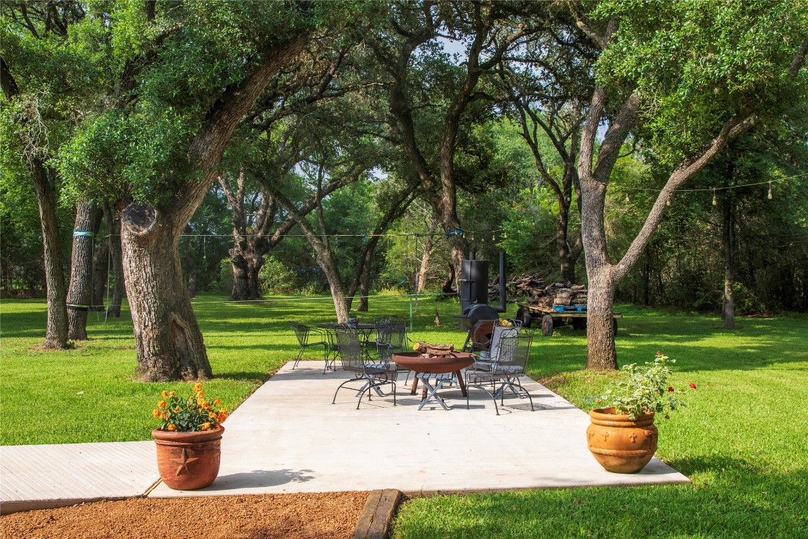 a view of a backyard with sitting area