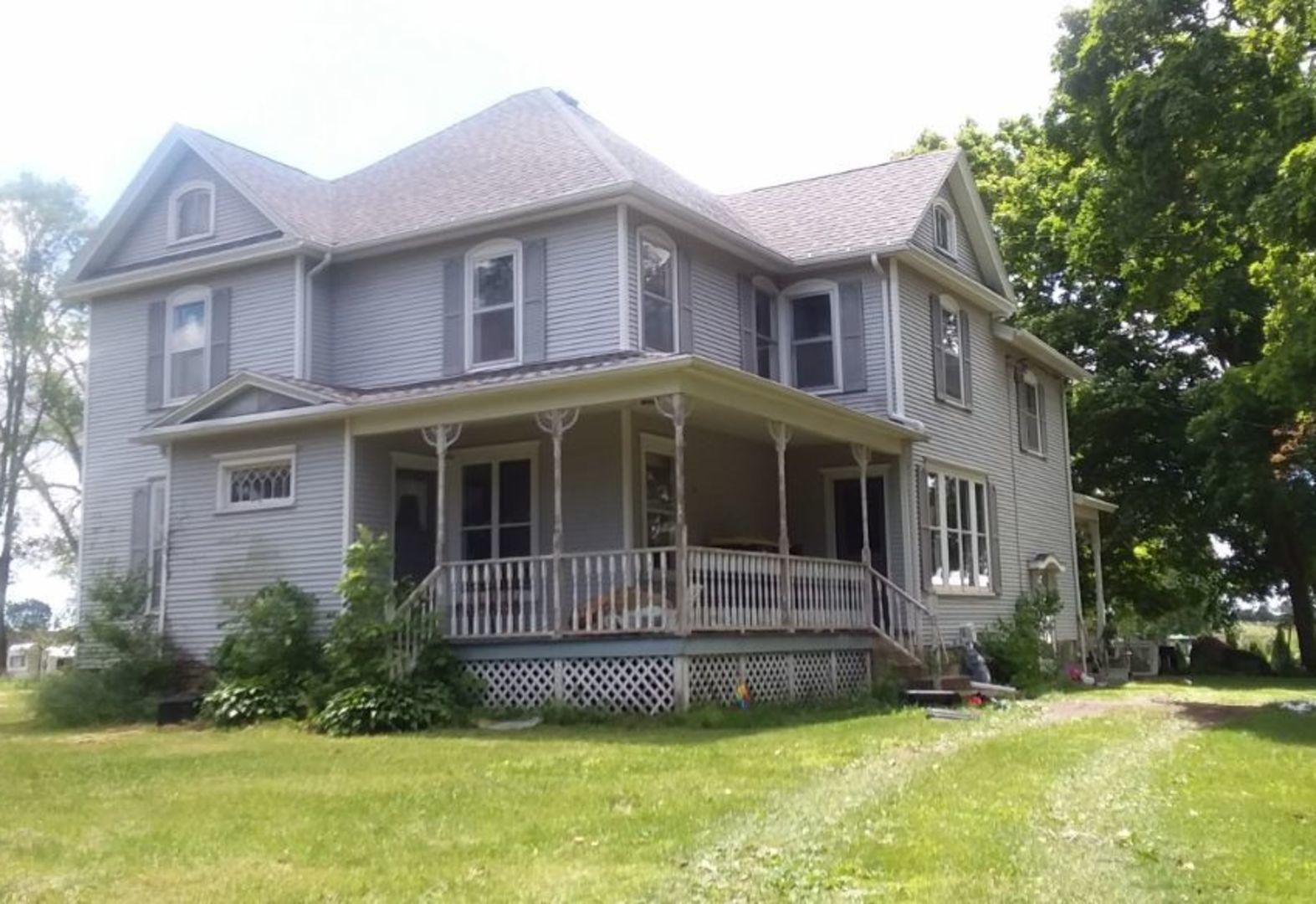 a front view of a house with a garden and yard