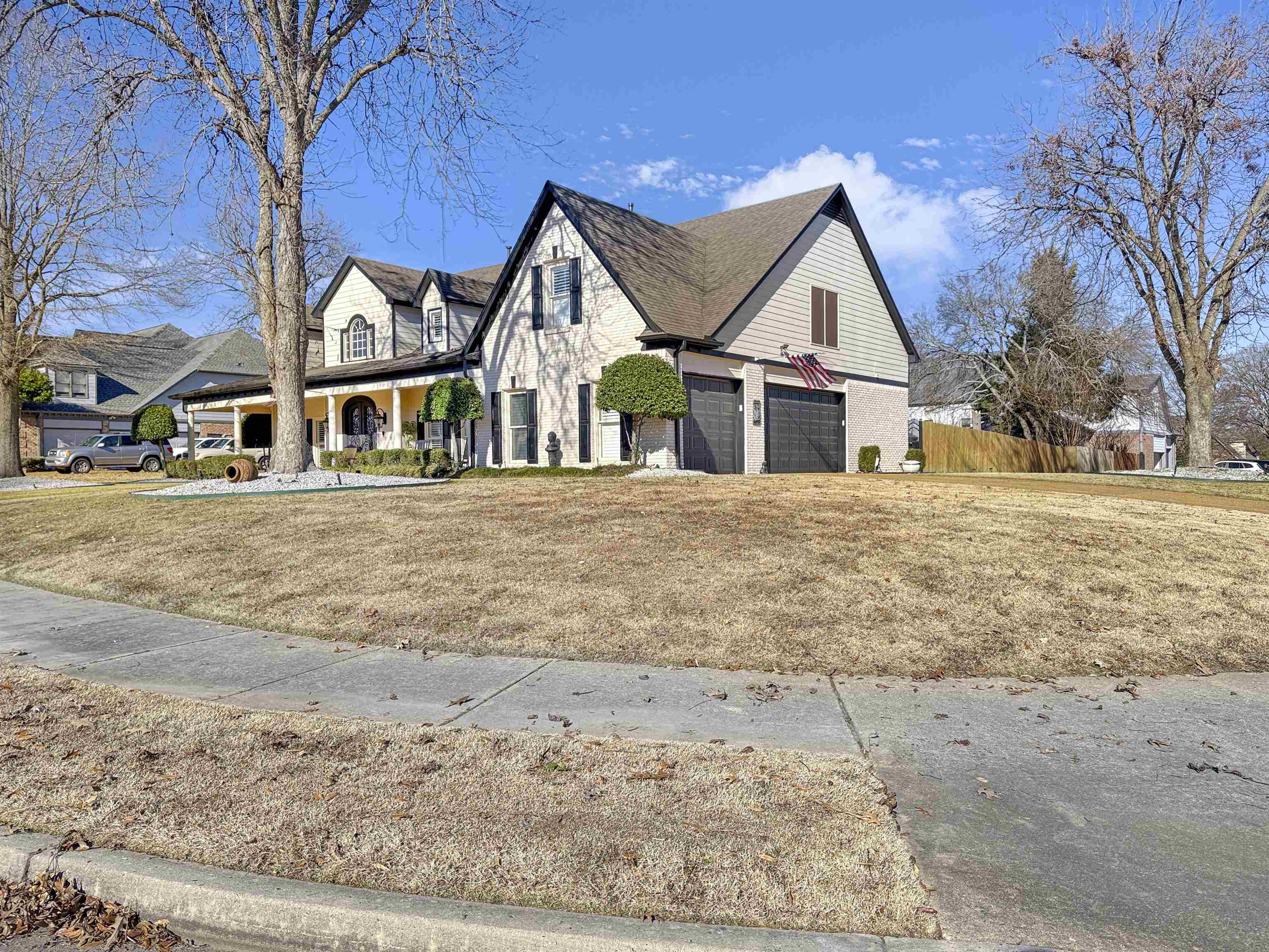 a view of a large white house with a yard