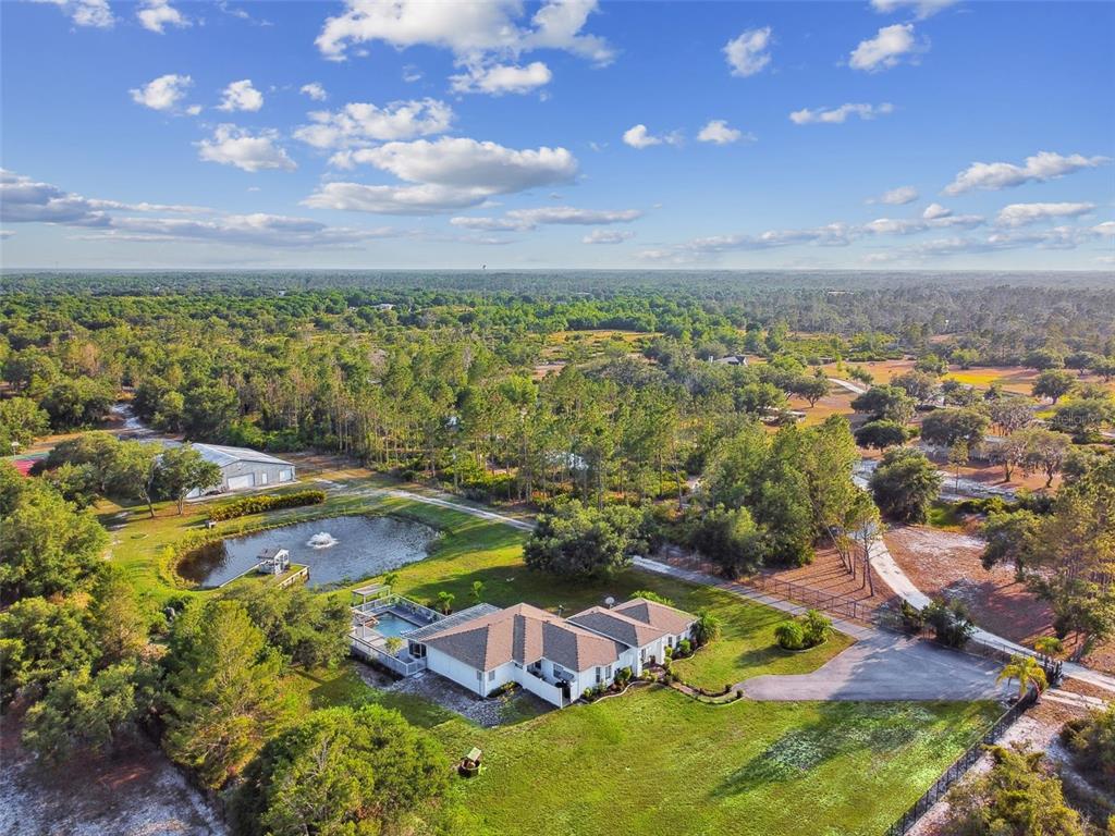 an aerial view of a house with a yard