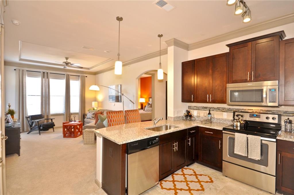 a kitchen with a sink stove and cabinets