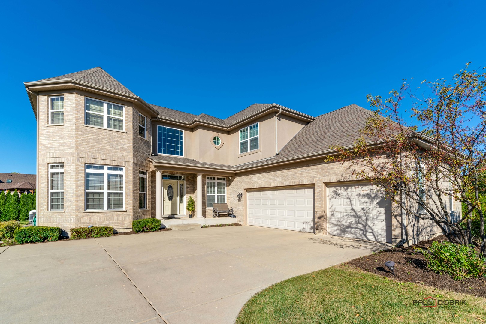 a front view of a house with a yard and garage