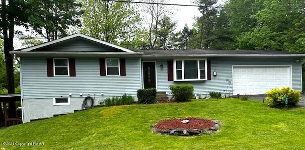 a view of a house with a yard and a garden