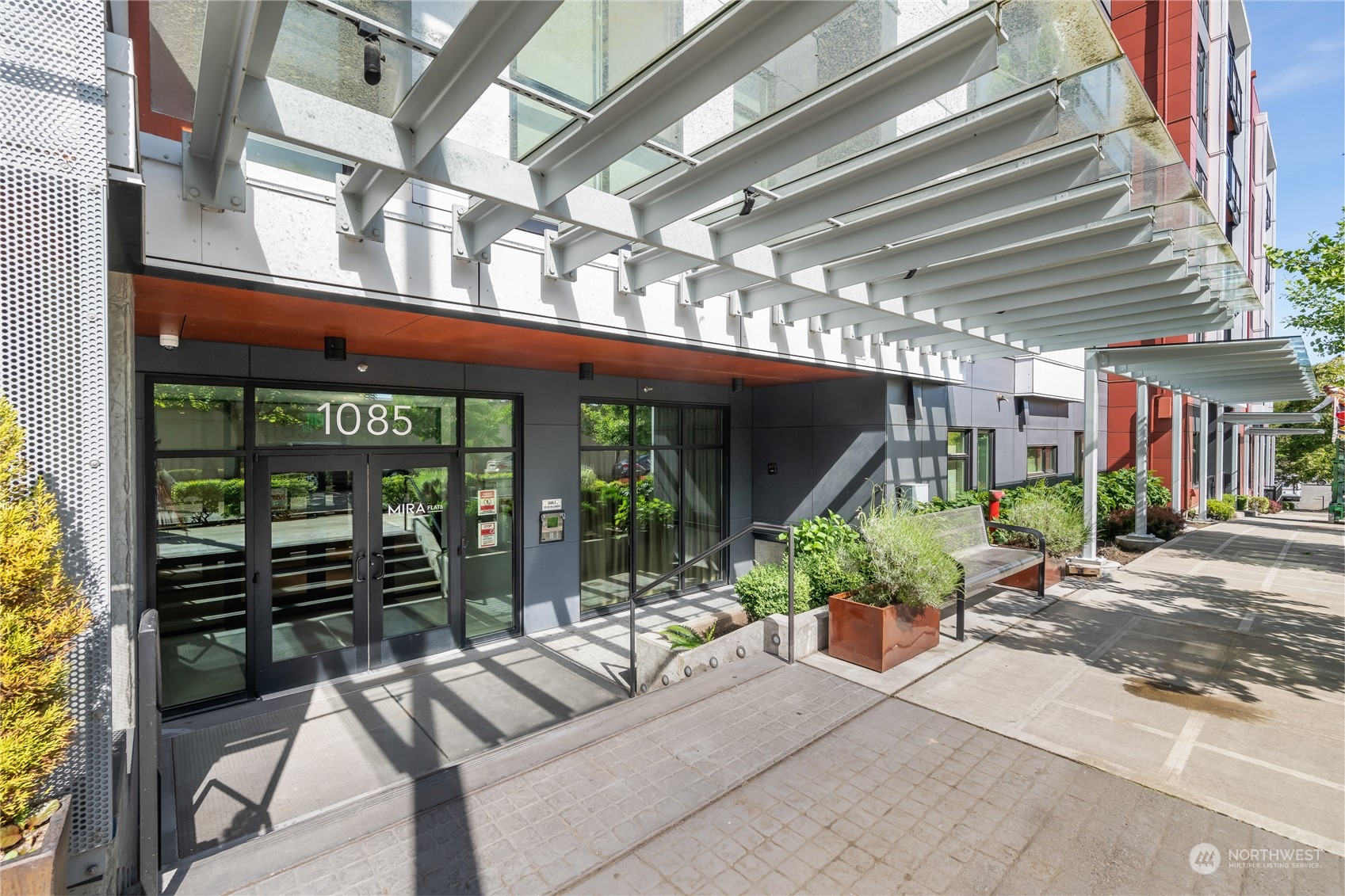 a building outdoor space with patio furniture and potted plants