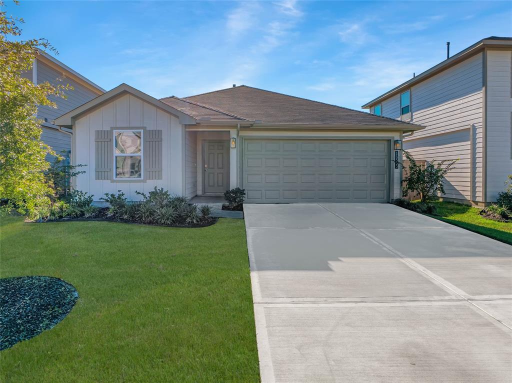 a view of a house with a yard and garage