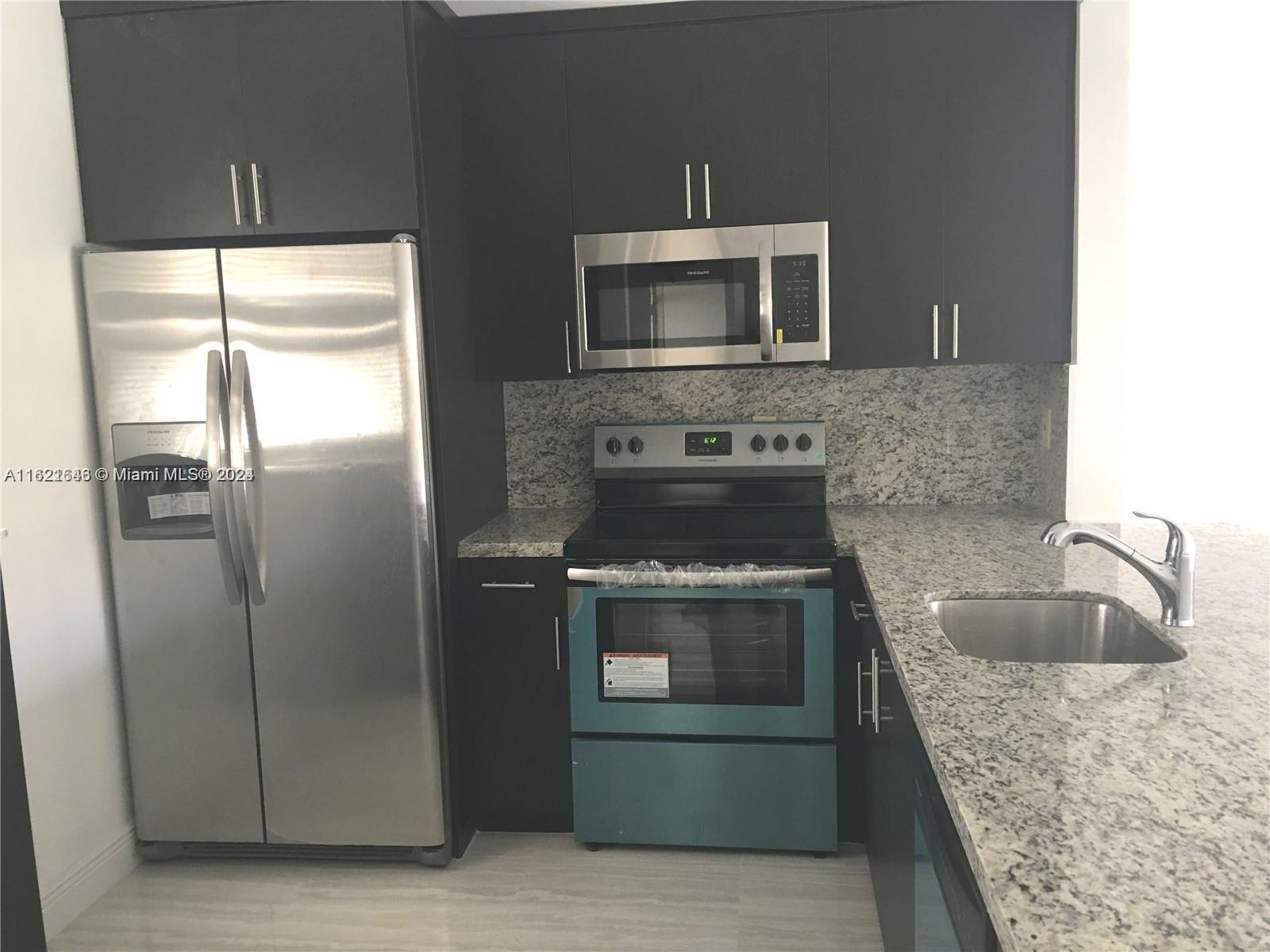 a kitchen with a stove microwave and refrigerator