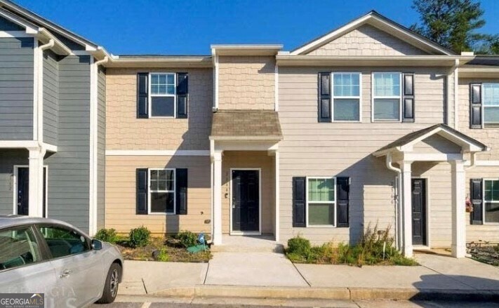 a front view of a house with a yard