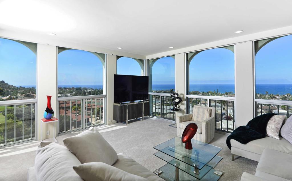 a living room with furniture a rug and a flat screen tv