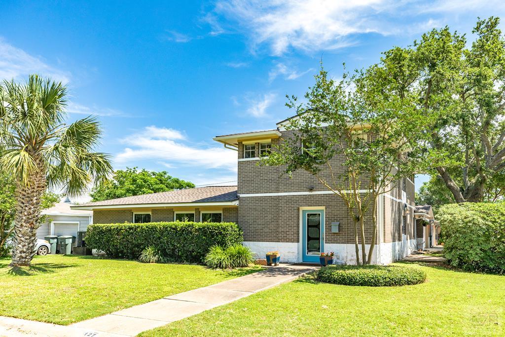 a front view of a house with a yard