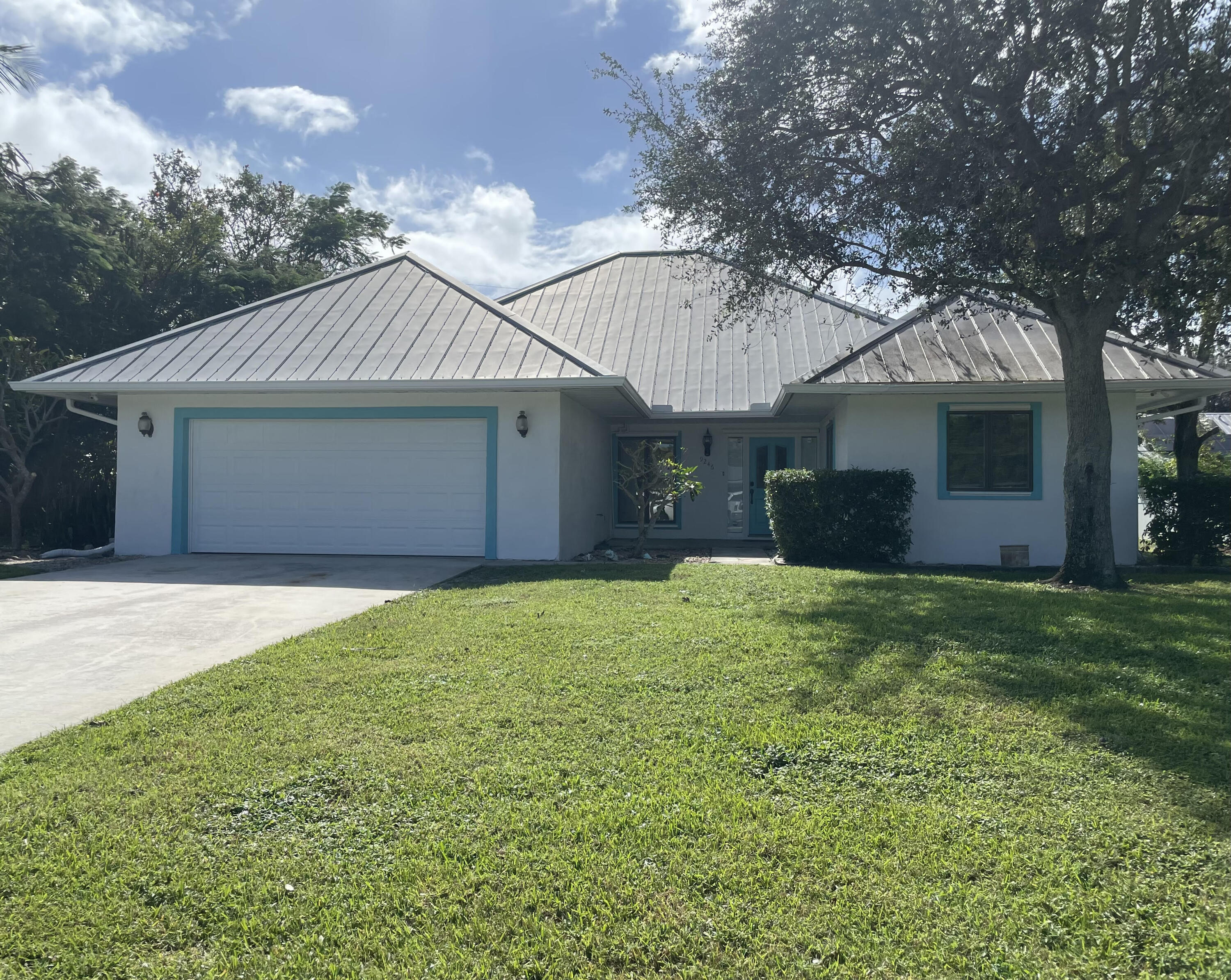 a front view of house with yard and trees