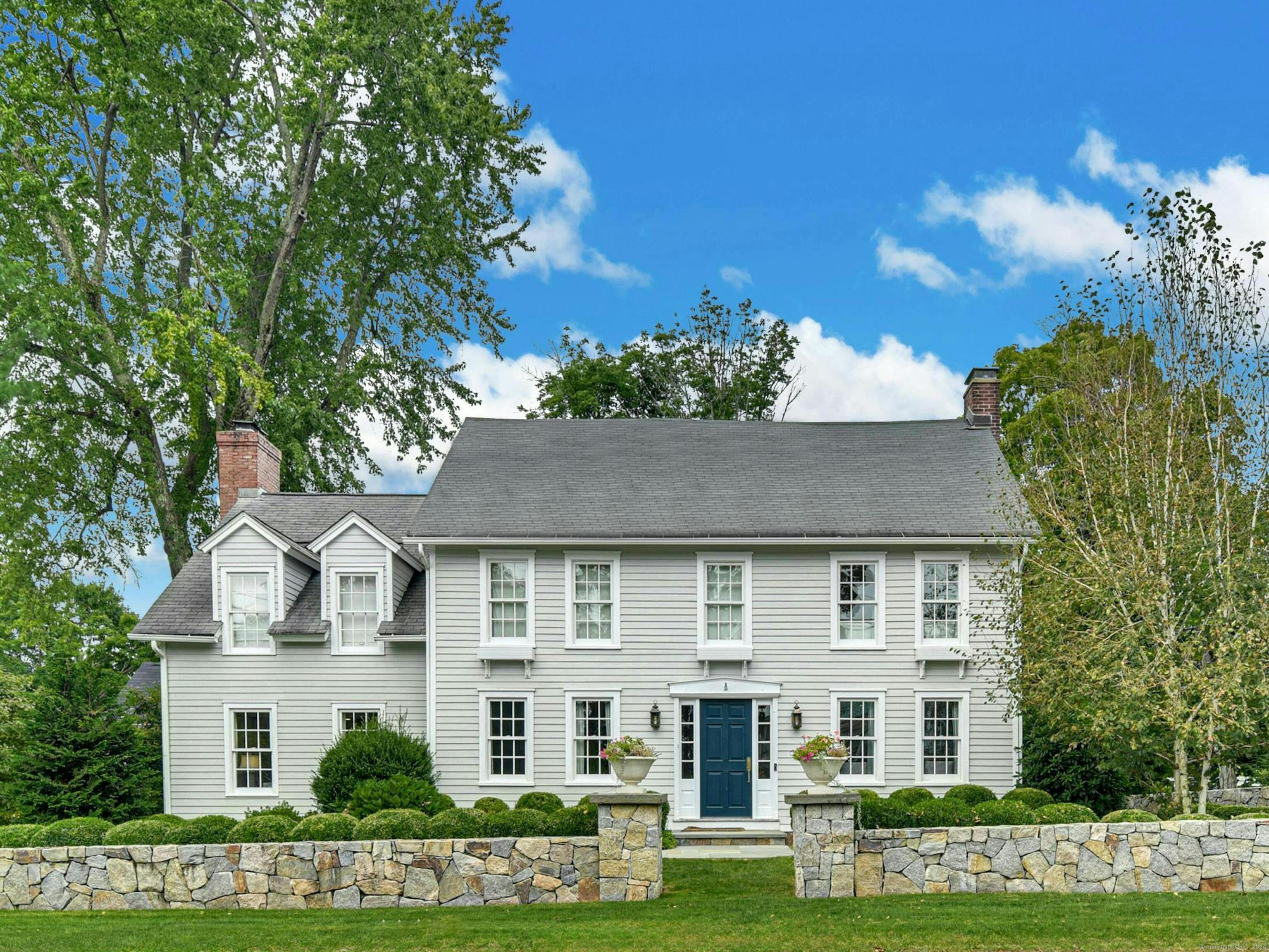 a front view of a house with a garden