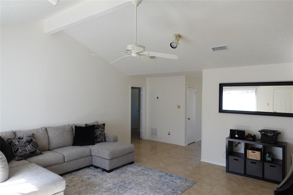 a living room with furniture a chandelier and a window