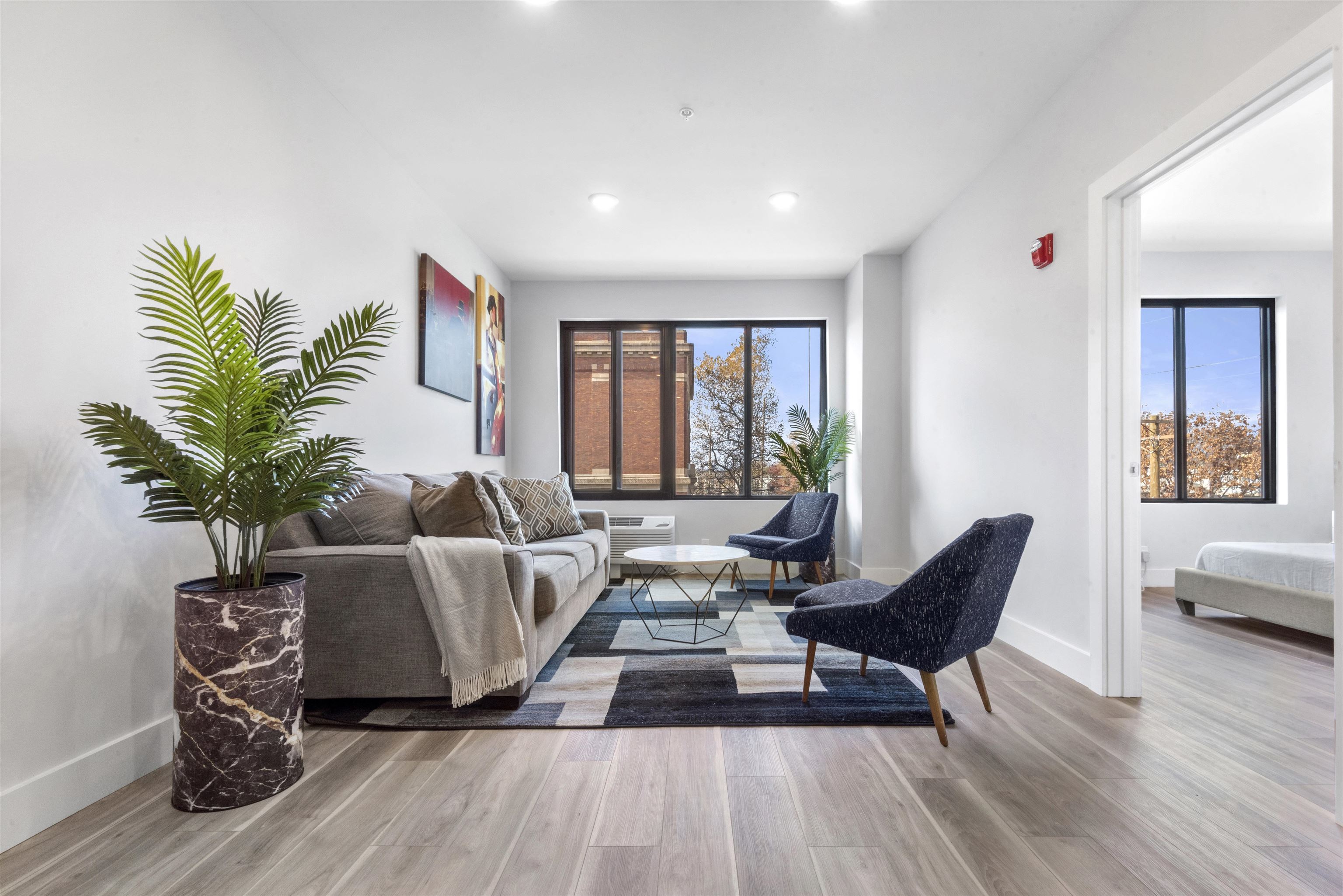 a living room with furniture and a large window