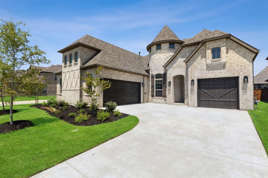 a front view of a house with a garden and yard