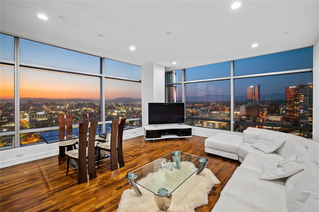 a living room with patio furniture and a floor to ceiling window