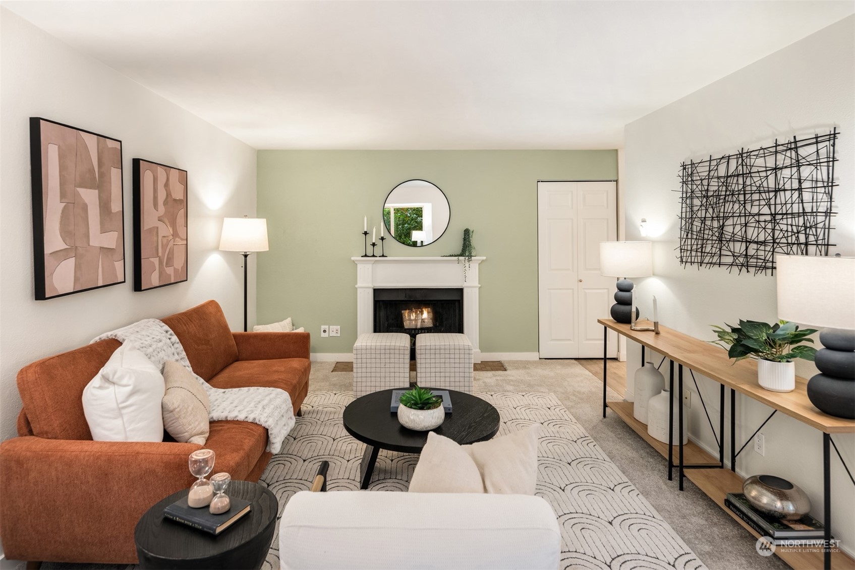 a living room with furniture a fireplace and a window