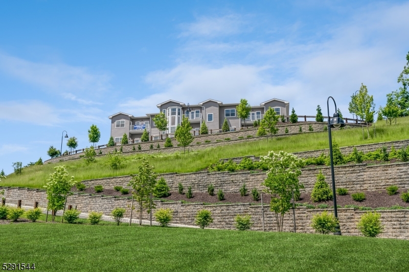 a view of a big house with a big yard and large trees