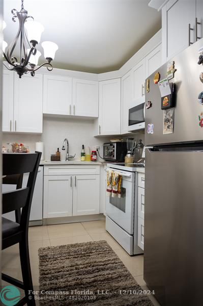 a kitchen with a sink cabinets and stainless steel appliances