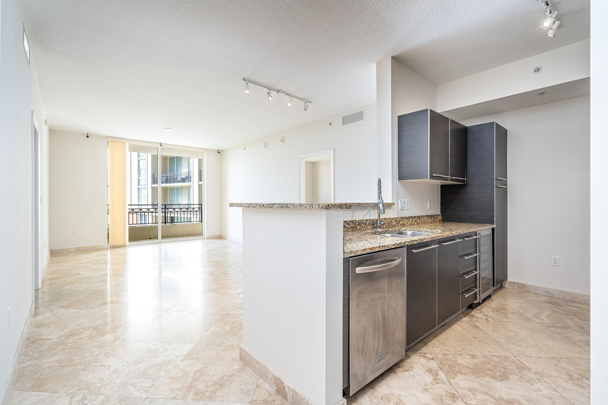 a large kitchen with kitchen island a sink stainless steel appliances and cabinets