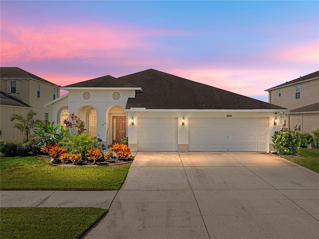 a front view of a house with a yard and garage