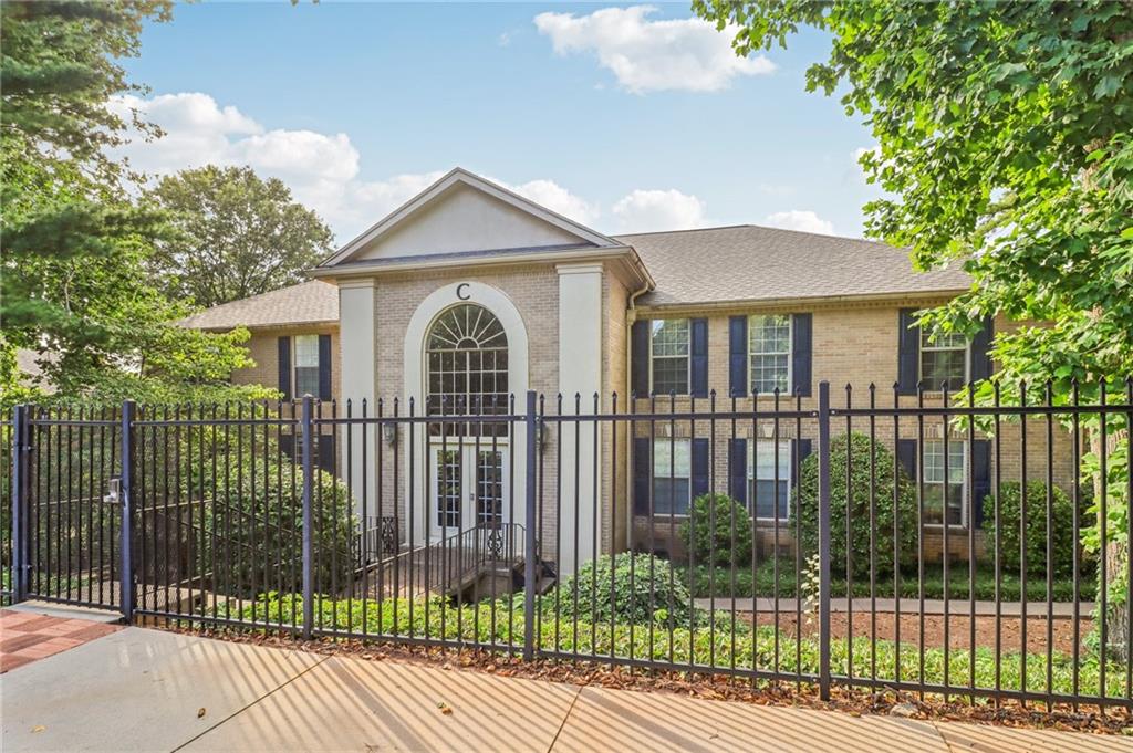 a view of a house with iron fence