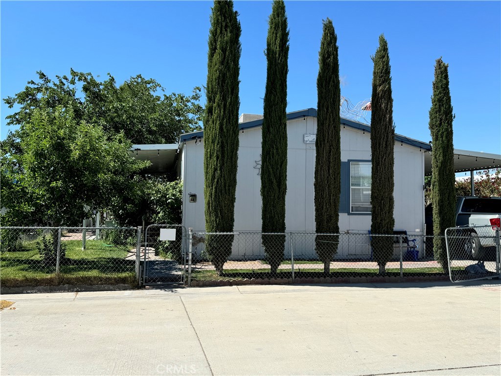 a front view of a building with trees