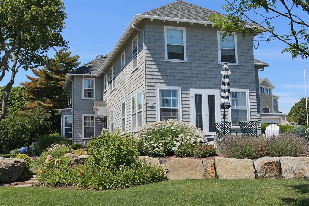 a front view of a house with a garden