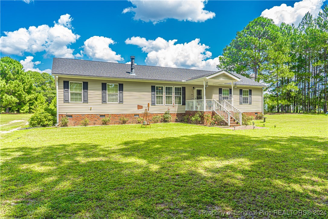 a front view of house with yard and green space