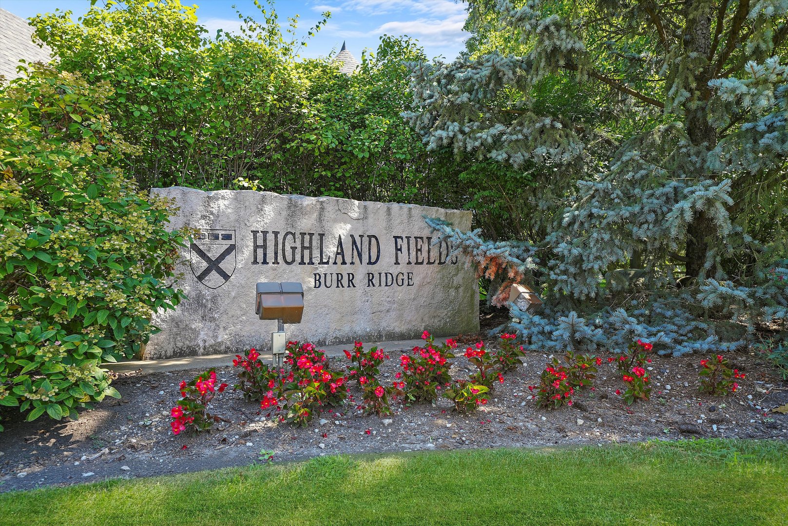 a sign that is in front of flowers