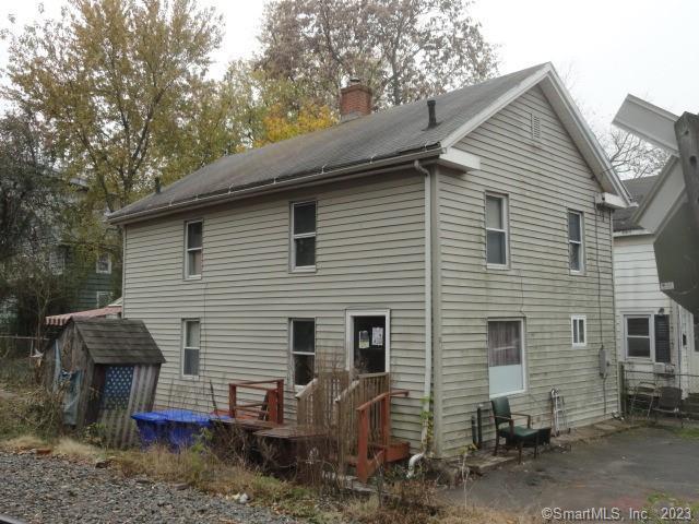 a view of a house with a yard and sitting area