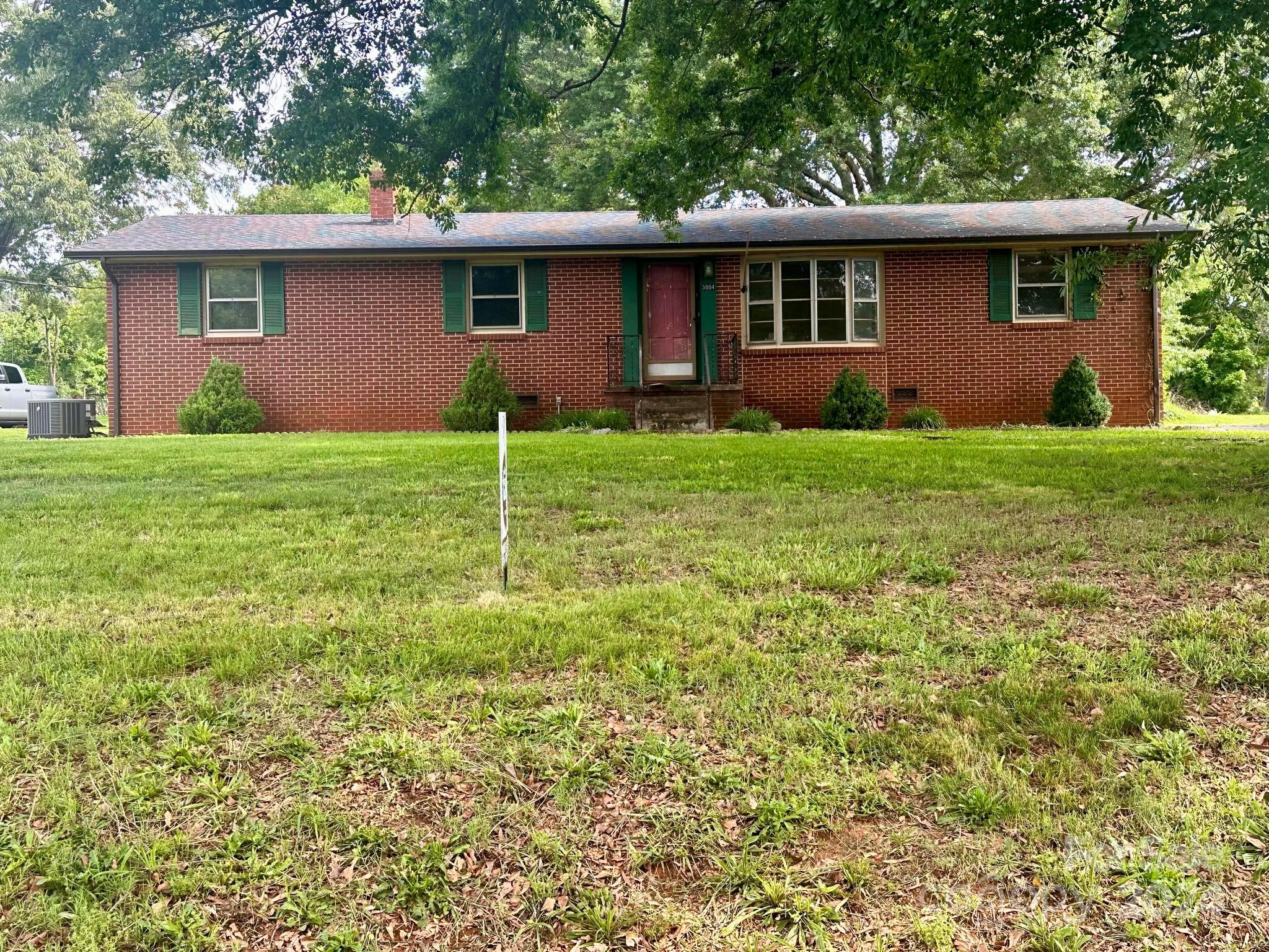 a view of a house with yard and a garden