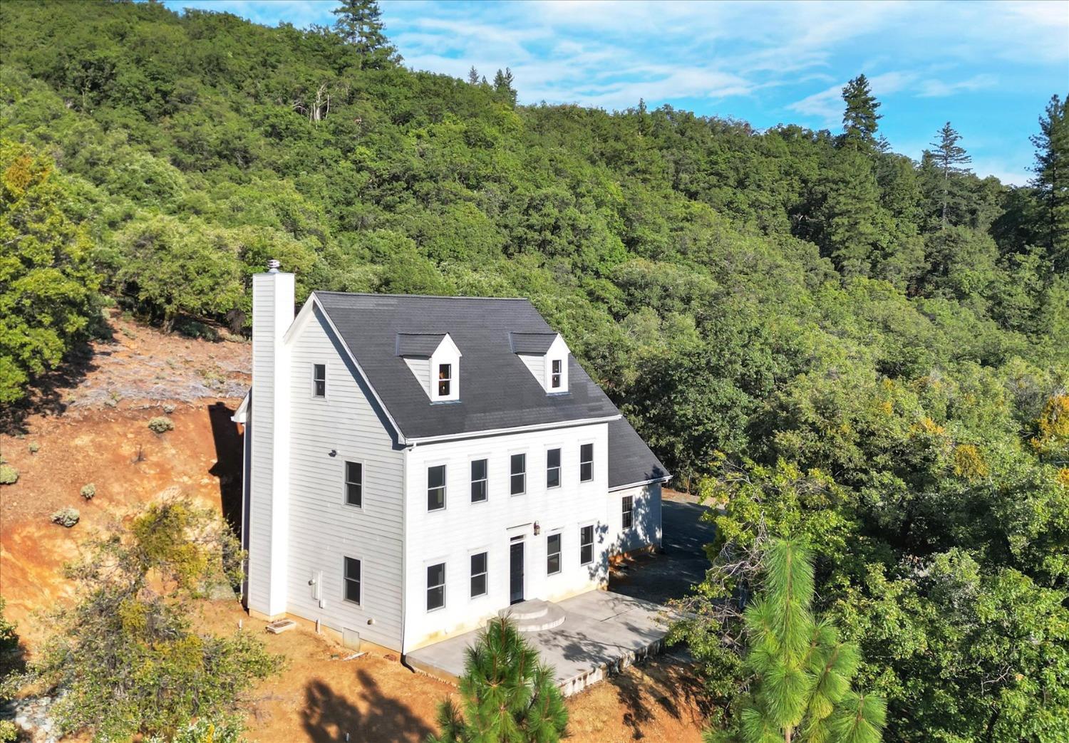 aerial view of a house with a yard