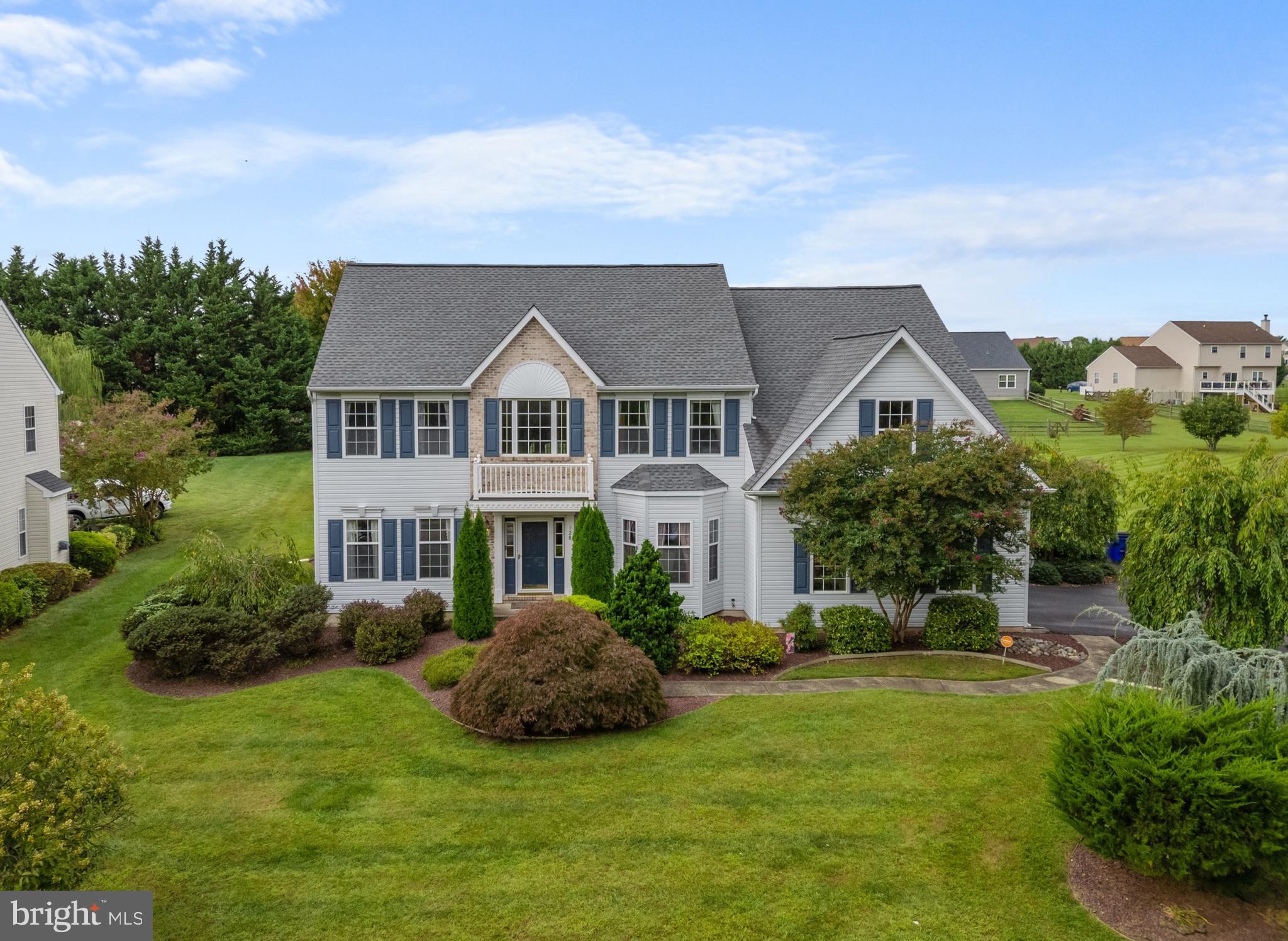 a front view of a house with a garden and plants