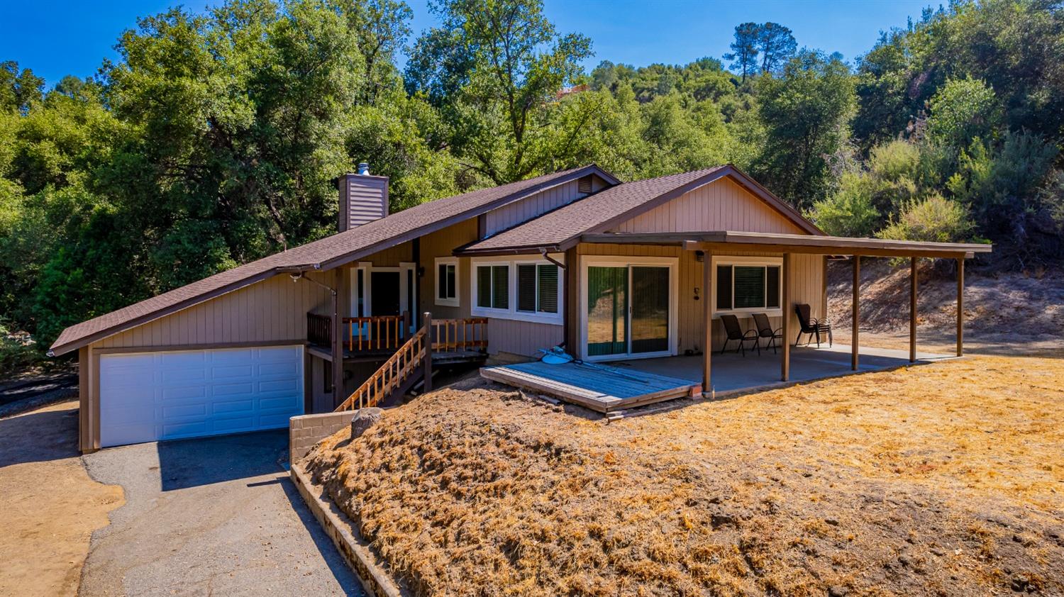 a view of a house with a patio and wooden fence