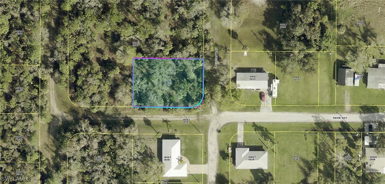 an aerial view of residential houses with outdoor space and trees