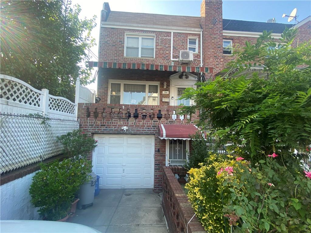 a front view of a house with a garden and patio