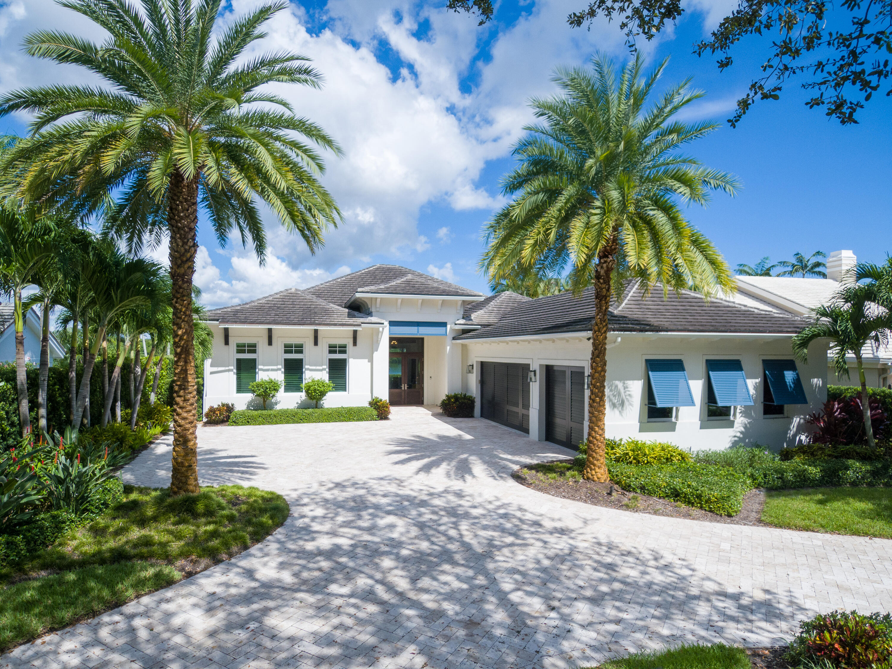 a house that has a palm tree in front of it