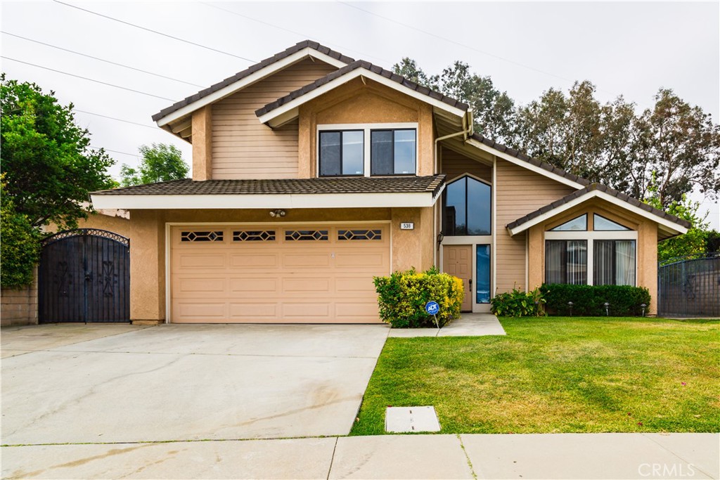 a front view of a house with a yard and garage